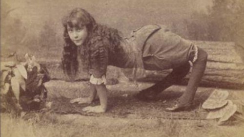 Ella Harper/ Camel Girl posing for a picture on all four limbs.